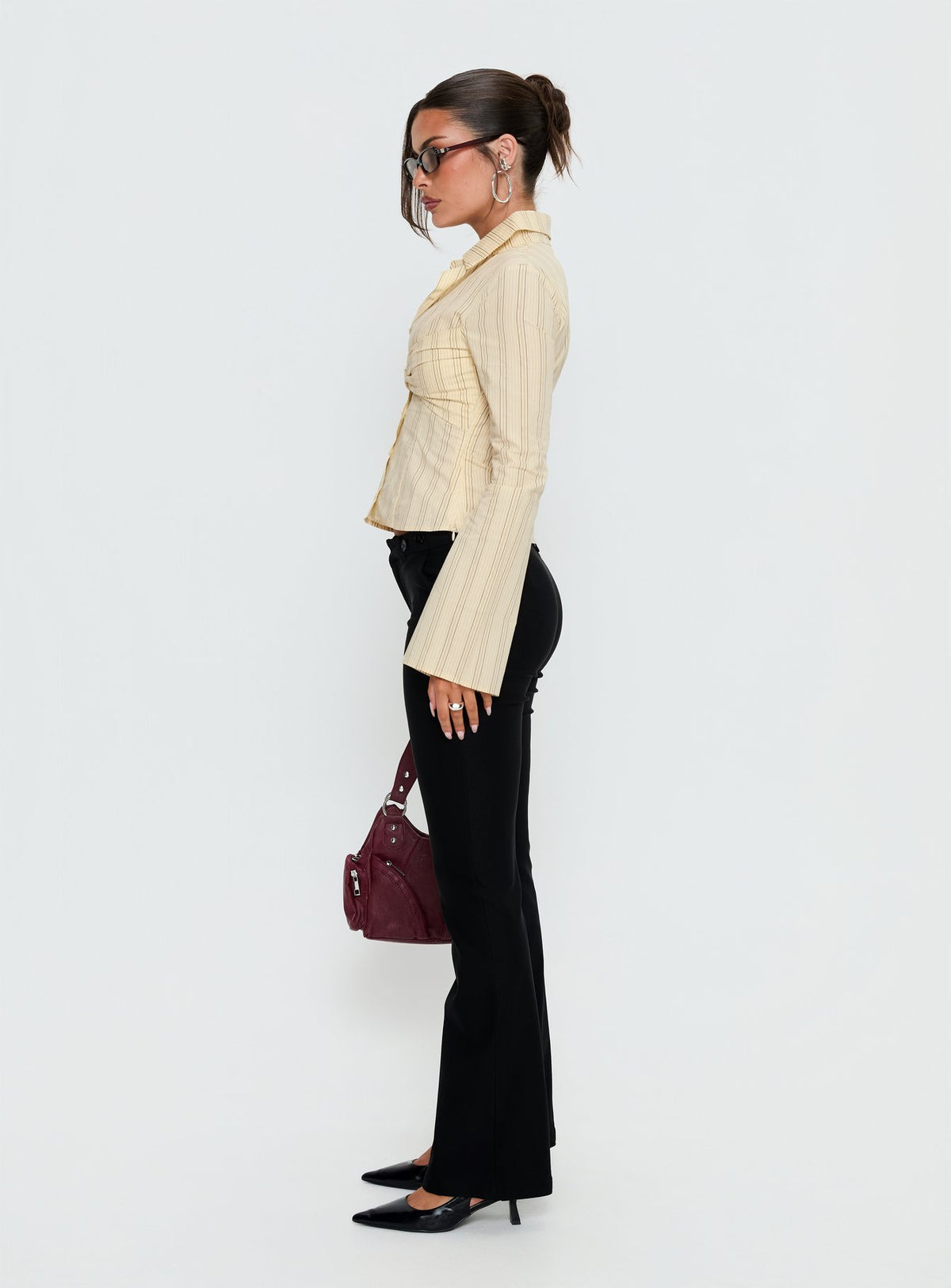 side view of model wearing Princess Polly Dariana Flare Pants Black Mid Rise Pants Pants 