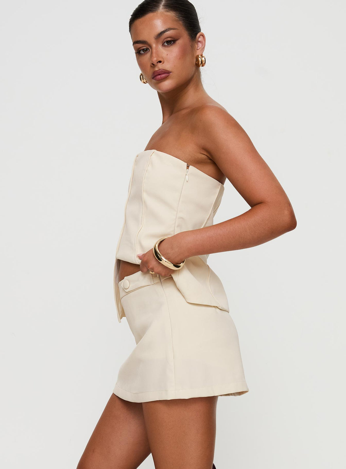 side view of model wearing Princess Polly Full Disclosure Skort Cream High Waisted Shorts 