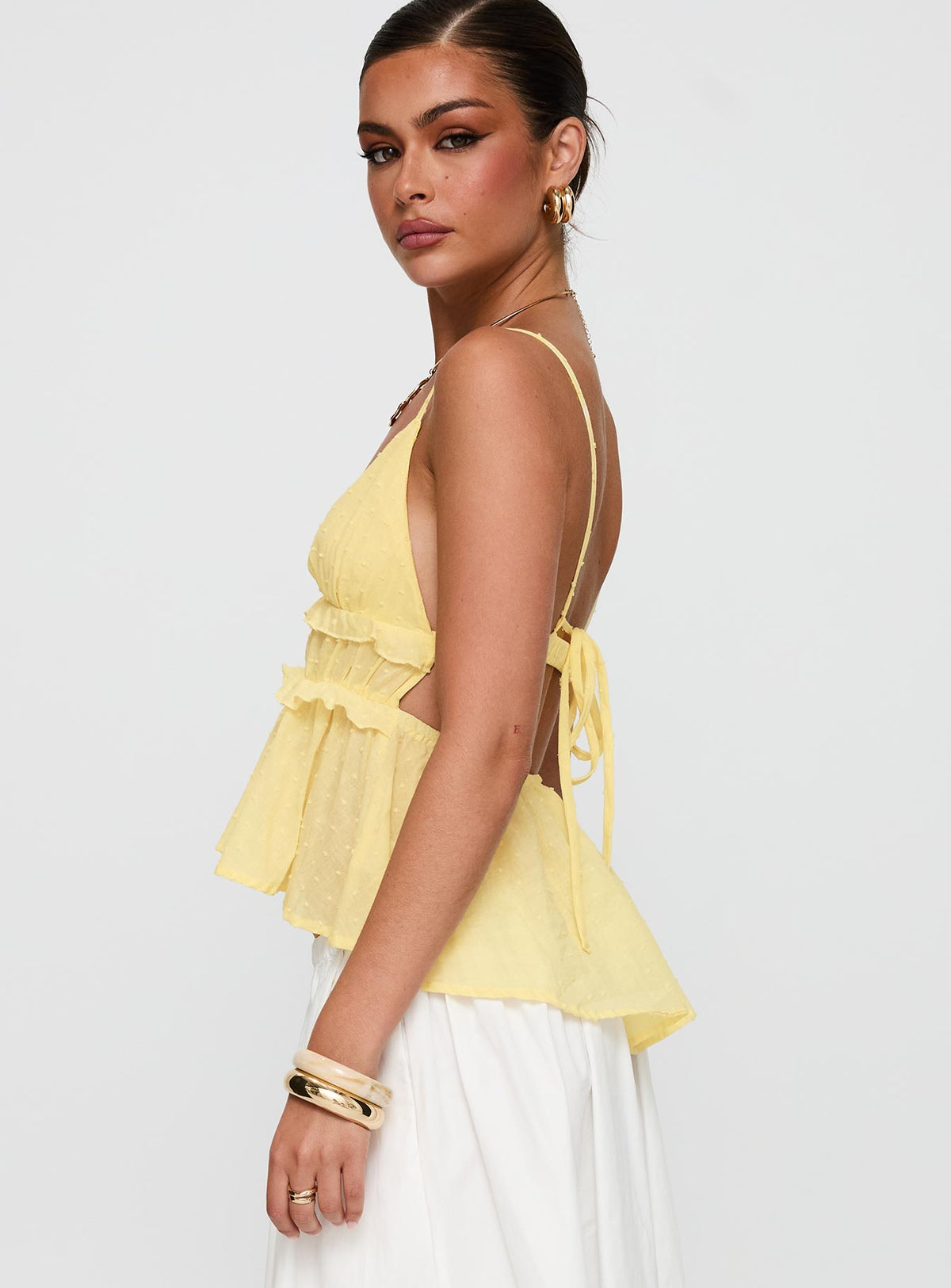 side view of model wearing Princess Polly Blondelle Frill Detail Top Yellow Sleeveless Plunger 