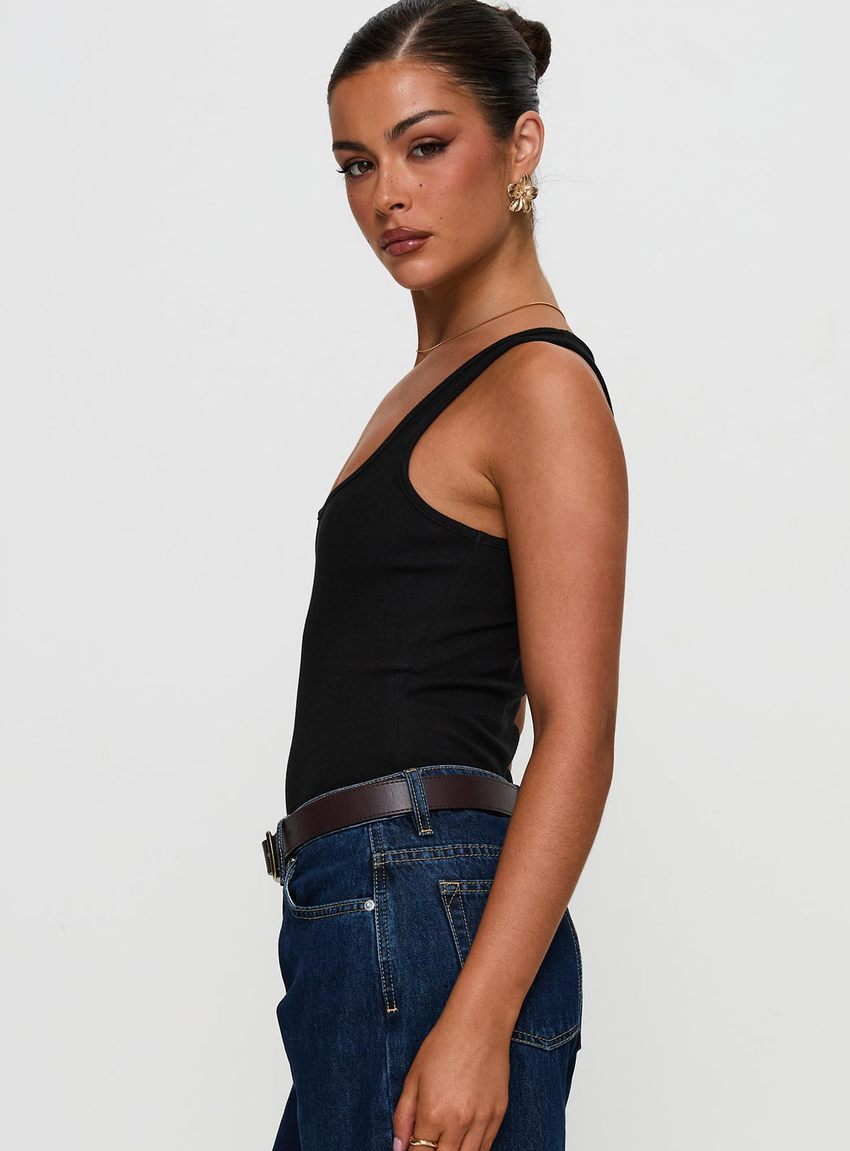 side view of model wearing Princess Polly Baseline Rib Bodysuit Black Sleeveless Bodysuit 