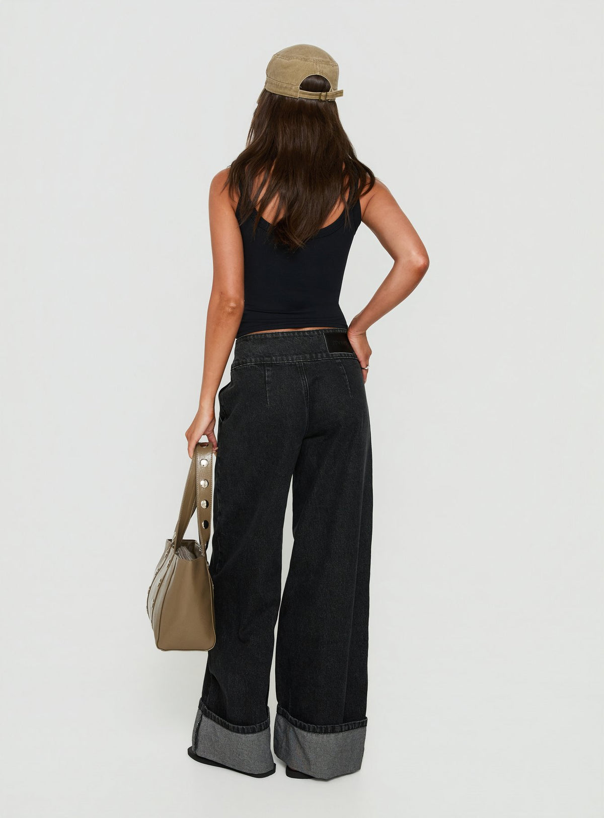 Featuring the Nikoletta Foldover Jeans Washed Black in high-rise wide-leg silhouette back view of model wearing Princess Polly