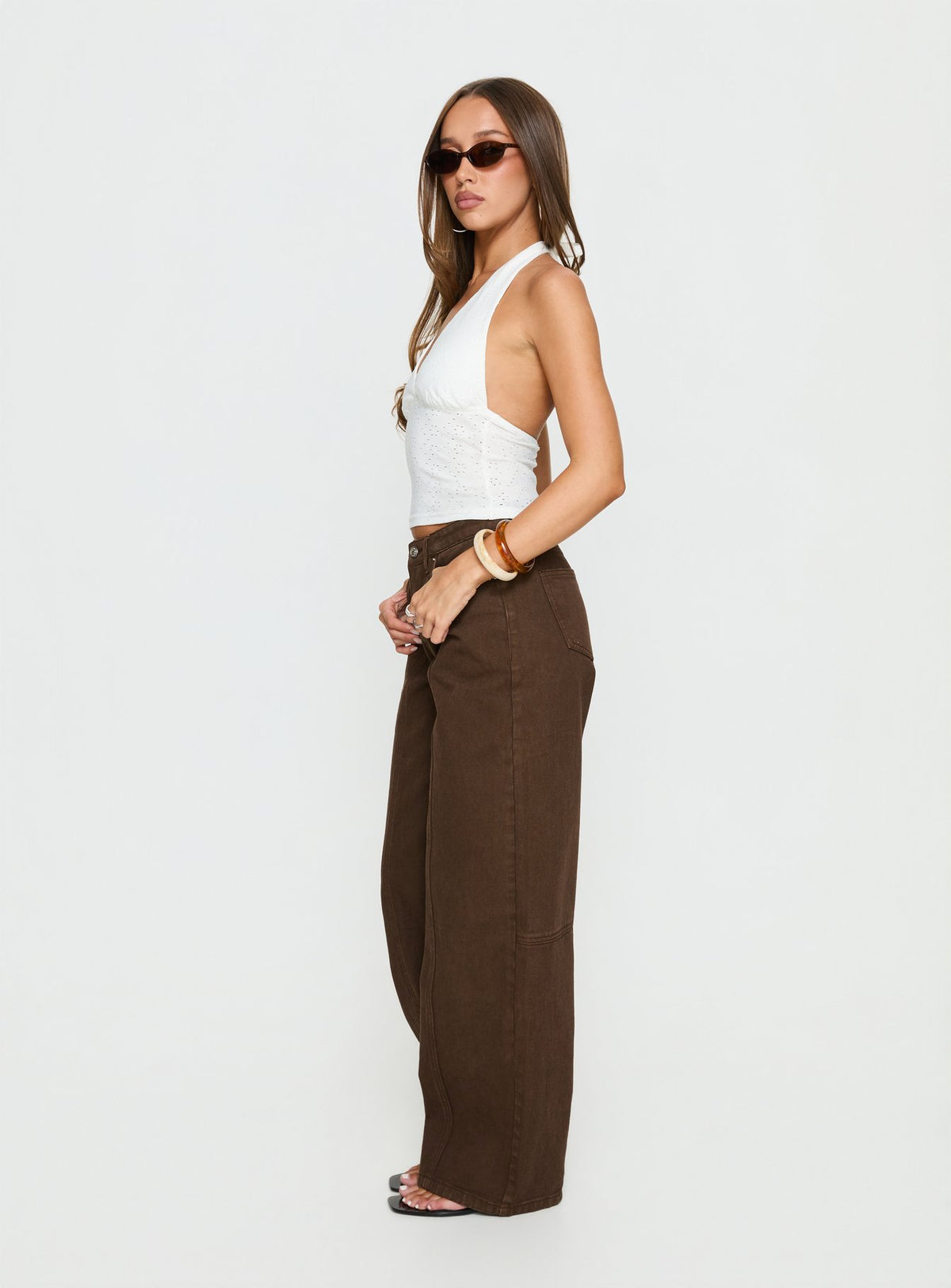 side view of model wearing Princess Polly Lando Low Rise Straight Leg Jeans Chocolate Mid Rise Jeans Jeans 