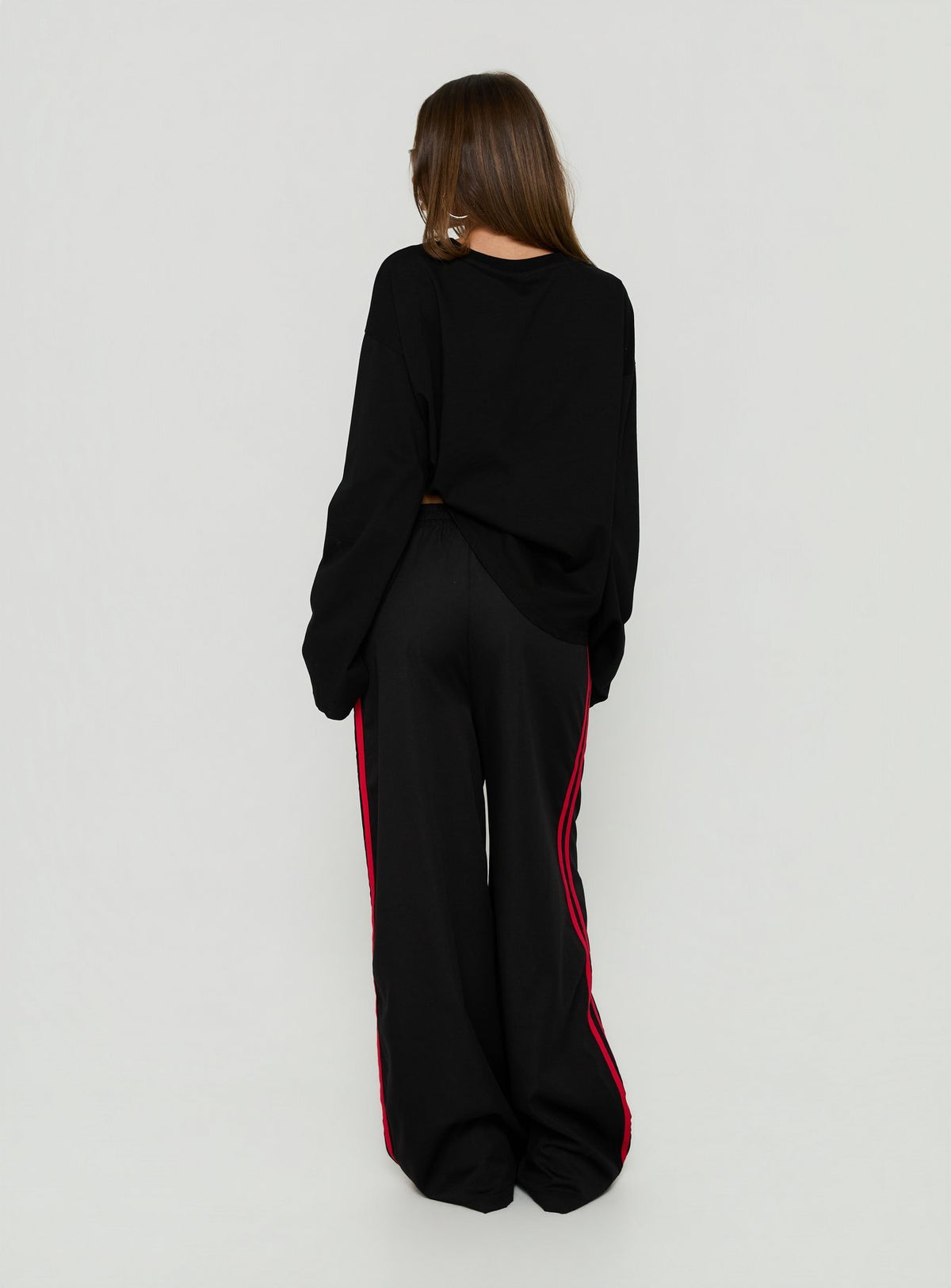 Designed with Fielder Track Pants Black / Red in womens-regular-pants featuring mid-rise back view of model wearing