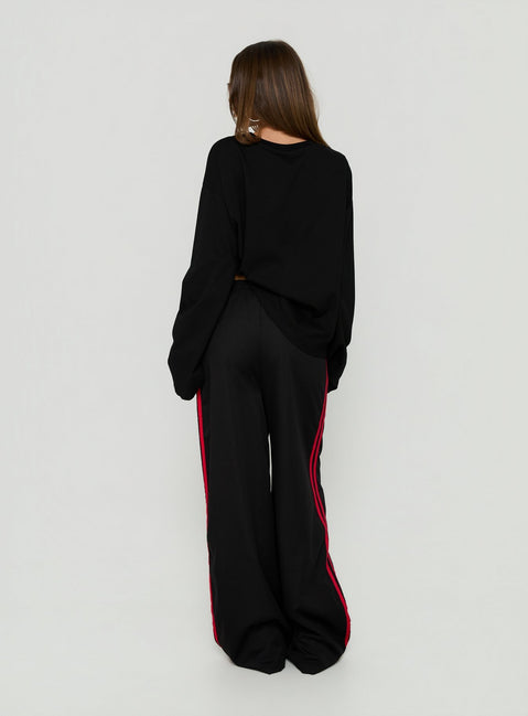 Designed with Fielder Track Pants Black / Red in womens-regular-pants featuring mid-rise back view of model wearing
