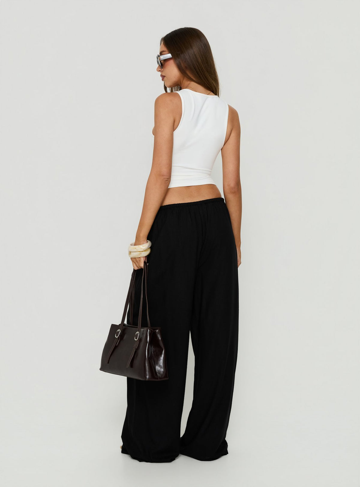 Designed with Peacemaker Tie Waist Relaxed Pants Black womens-regular-pants featuring mid-rise back view of model wearing