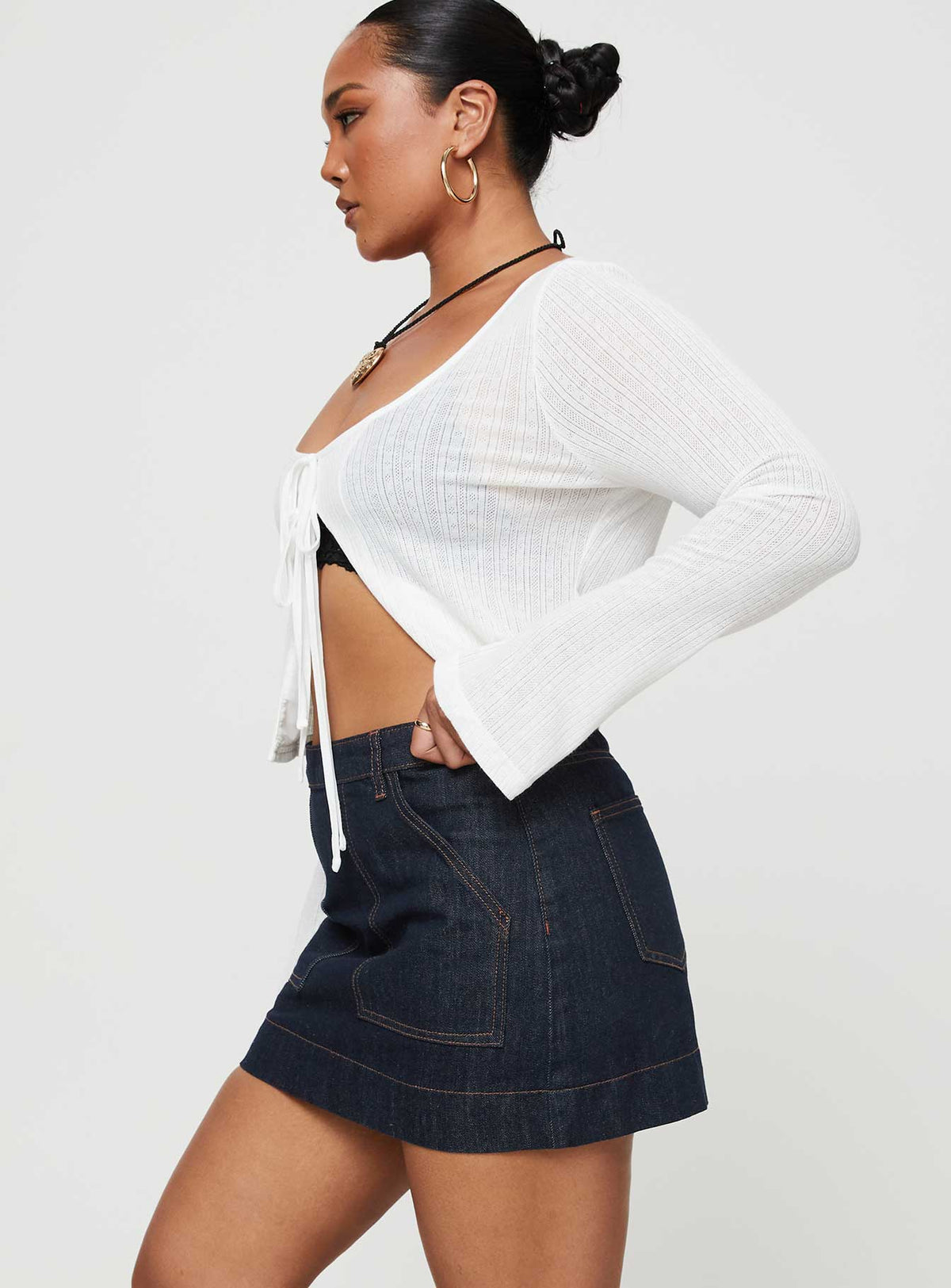  side view of model wearing Princess Polly Hughes Mini Skirt Dark Wash Denim Petite Mini Skirts Skirts 