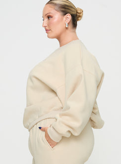 side view of model wearing Princess Polly Princess Polly Crew Neck Sweatshirt Block / Cursive Text Stone Curve regular Jumpers 