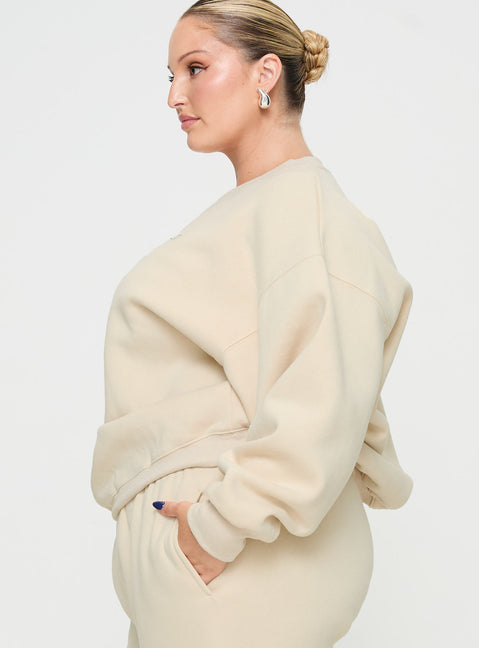 side view of model wearing Princess Polly Princess Polly Crew Neck Sweatshirt Block / Cursive Text Stone Curve regular Jumpers 