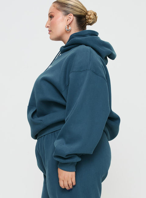 side view of model wearing Princess Polly Princess Polly Hooded Sweatshirt Block / Cursive Text Slate Curve Jumpers 
