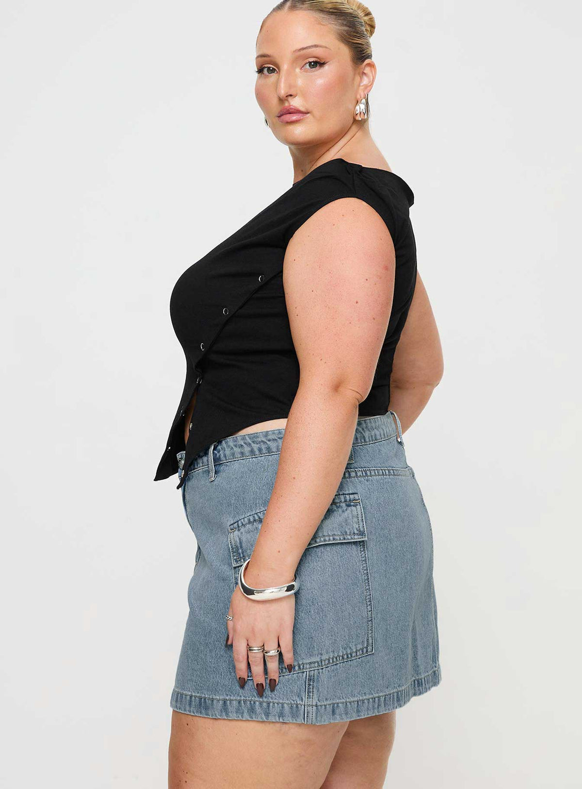   side view of model wearing Princess Polly Zakai Cargo Denim Mini Skirt Light Blue Denim Curve Mini Skirts Skirts 