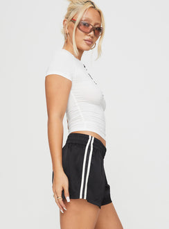 side view of model wearing Princess Polly 444 Shorts Black Low Rise Shorts 