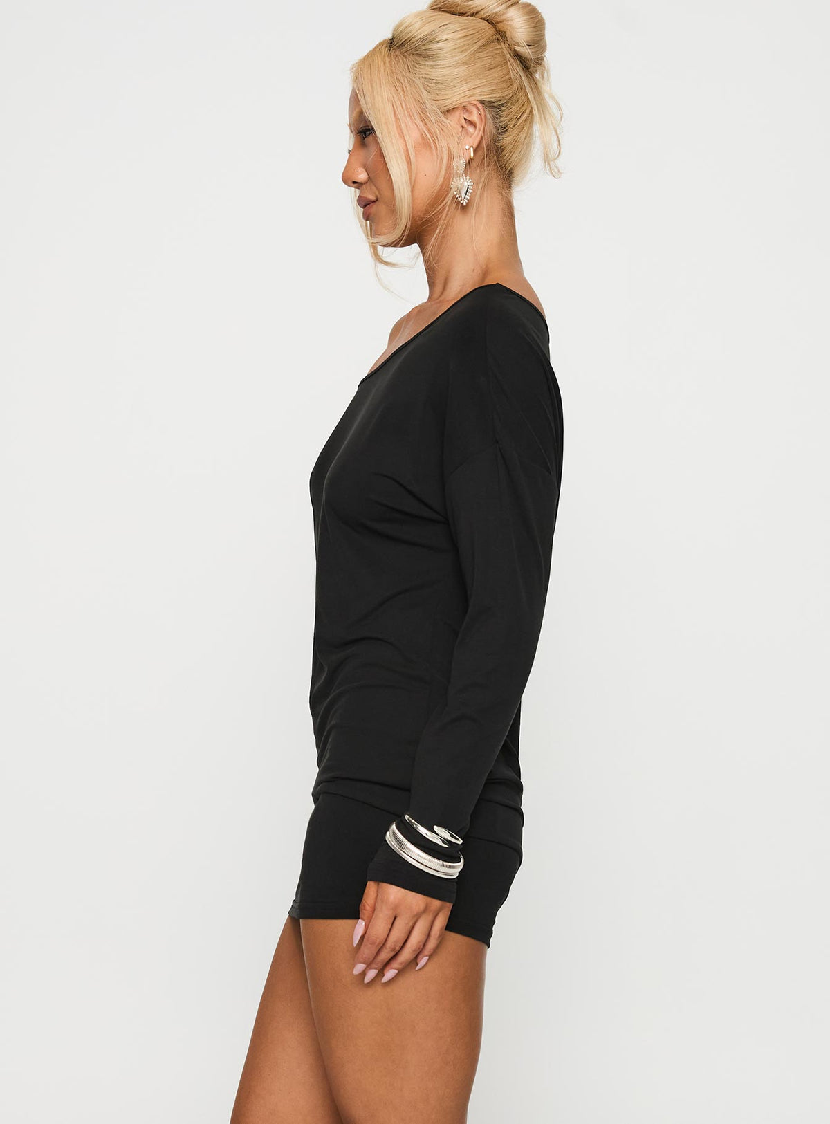 side view of model wearing Princess Polly Shelisa Mini Dress Black Asymmetric Neckline 