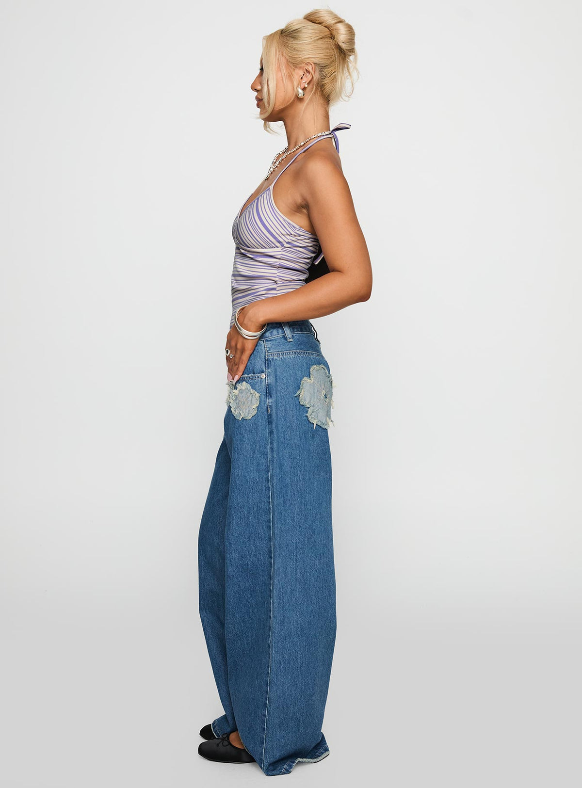 side view of model wearing Princess Polly A Keeper Flower Patch Low Rise Wide Leg Jeans Mid Blue Low Rise Jeans Jeans 