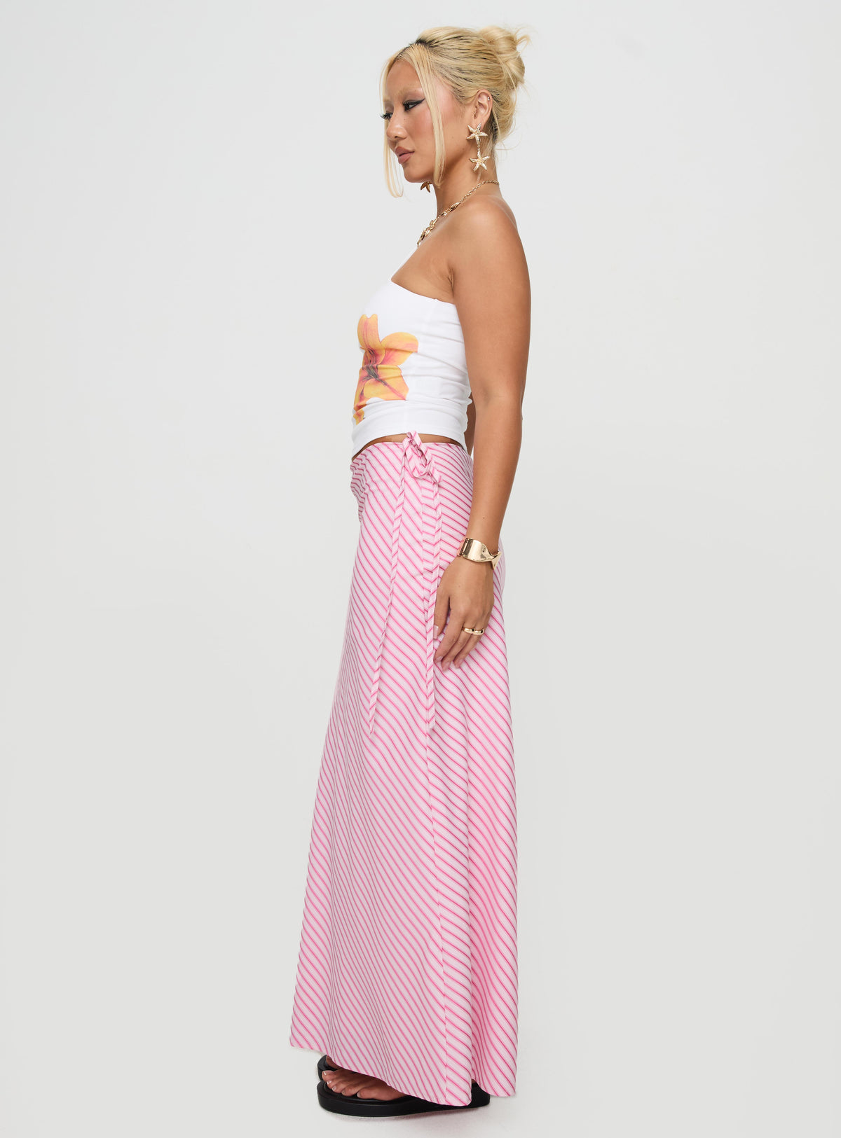   side view of model wearing Princess Polly Fluttering Maxi Skirt Pink Stripe Maxi Skirts Skirts 