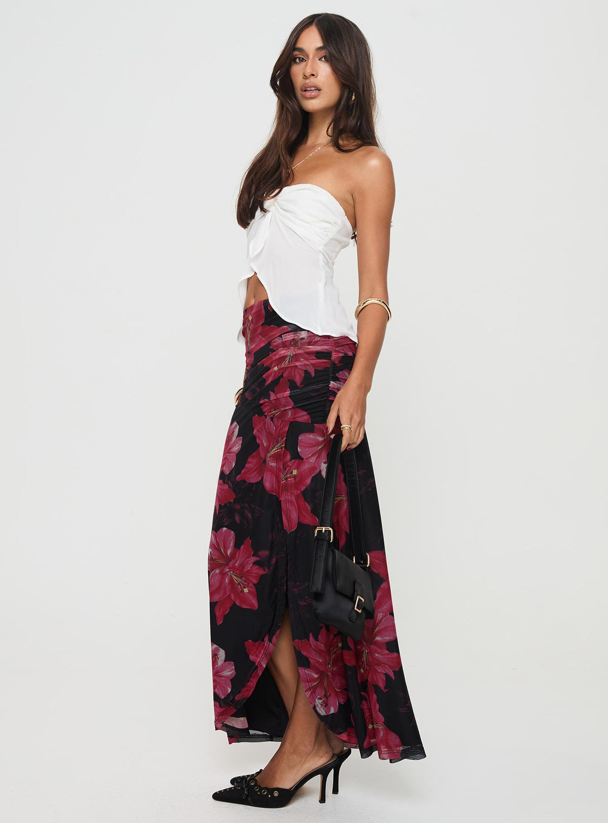   side view of model wearing Princess Polly Cooperi Maxi Skirt Black / Red Floral Maxi 