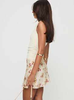   side view of model wearing Princess Polly Sonnet Mini Skirt Cream / Multi Floral Mini Skirts Skirts 