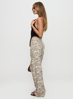 side view of model wearing Princess Polly Top Model Low Rise Straight Leg Jeans Zebra Mid Rise Jeans Jeans 