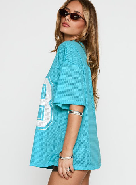 side view of model wearing Princess Polly 98 Sports Graphic Top Blue Half Sleeves V-Neck 