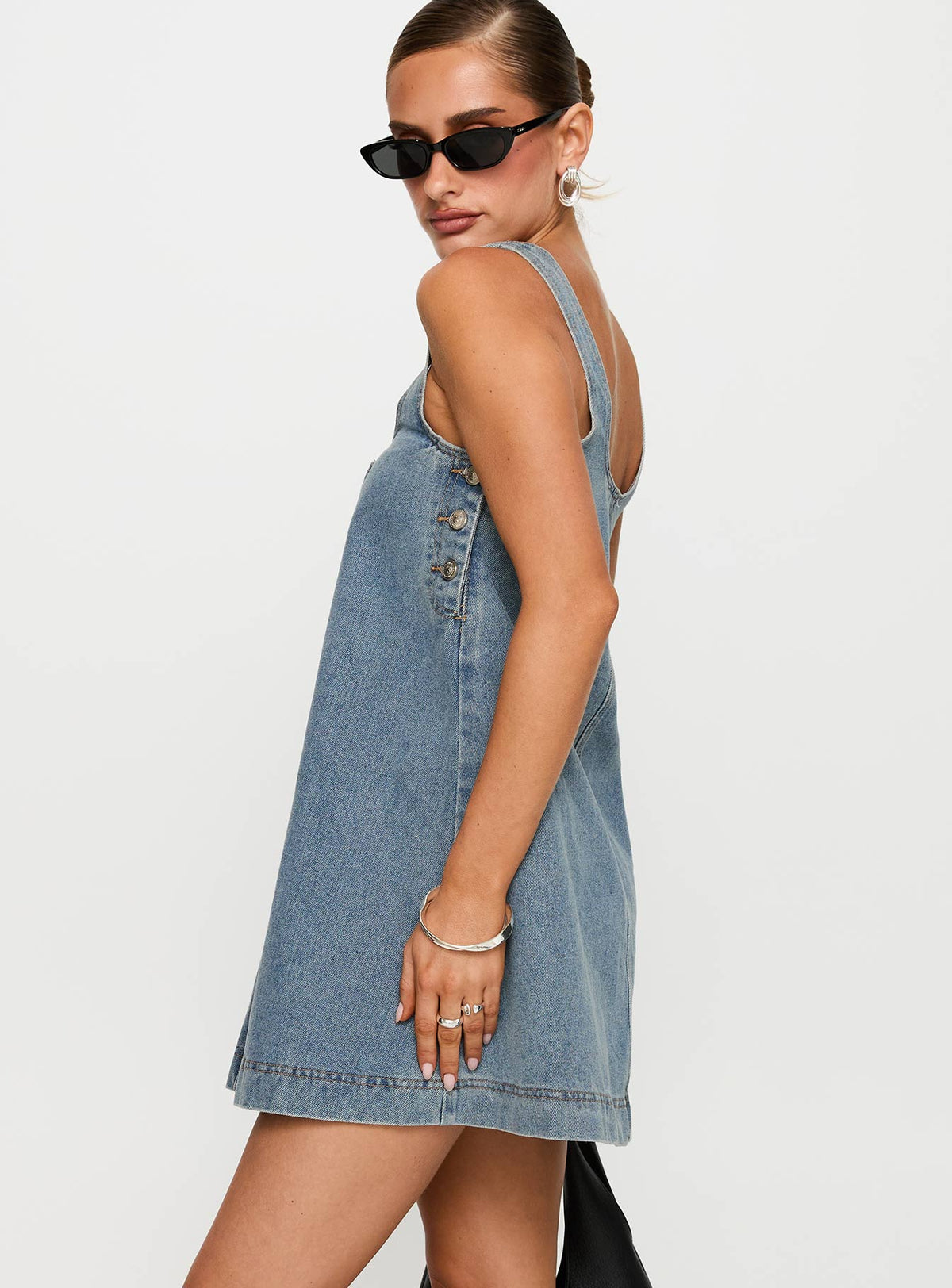 side view of model wearing Princess Polly State Of Mind Mini Dress Blue Denim Scoop Neck 