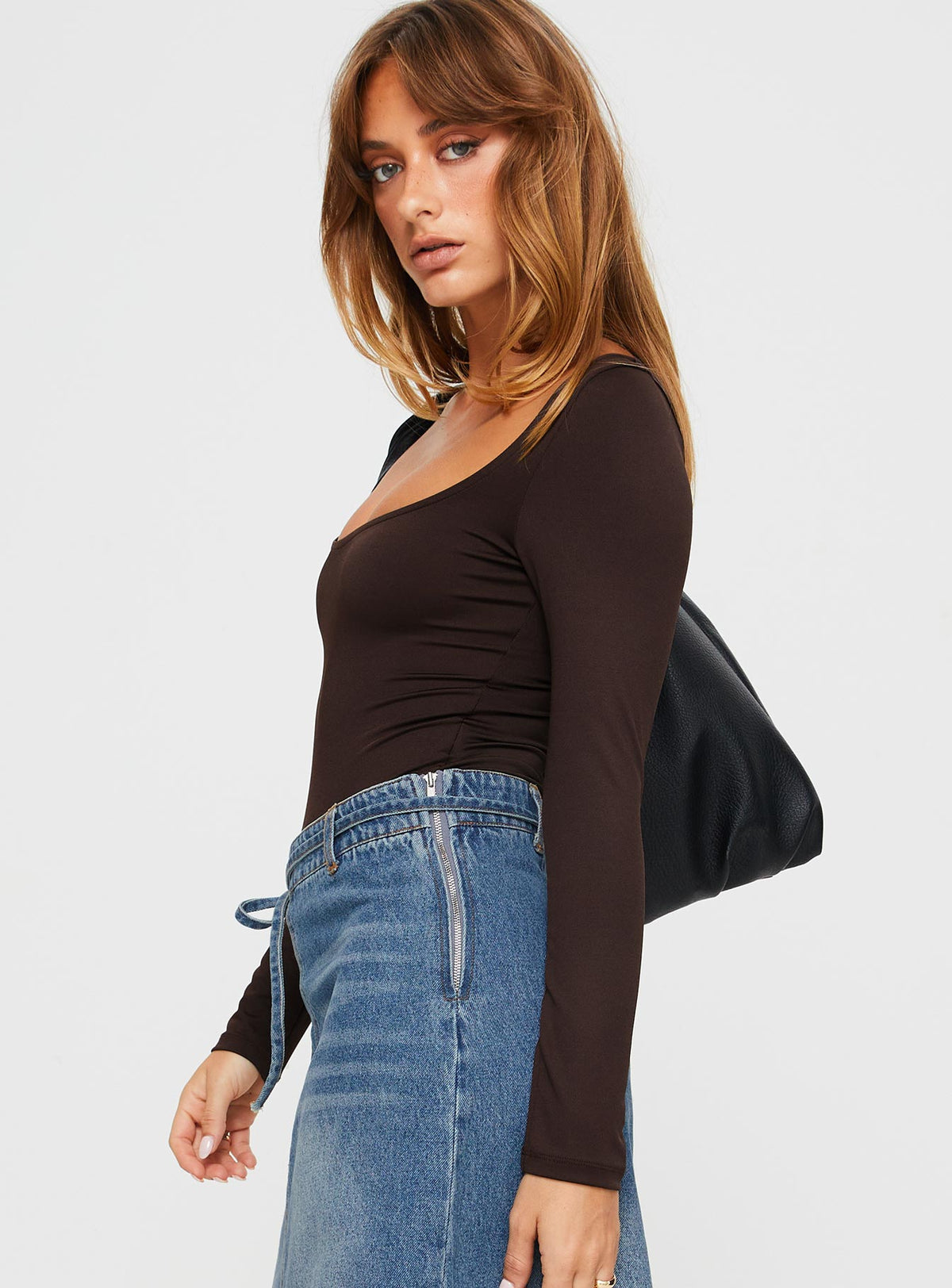 side view of model wearing Princess Polly Ellery Bodysuit Brown Tall Long Sleeve Tops Bodysuit 
