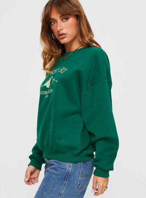 side view of model wearing Princess Polly Apres Ski Crew Neck Sweatshirt Green / Cream Jumpers 