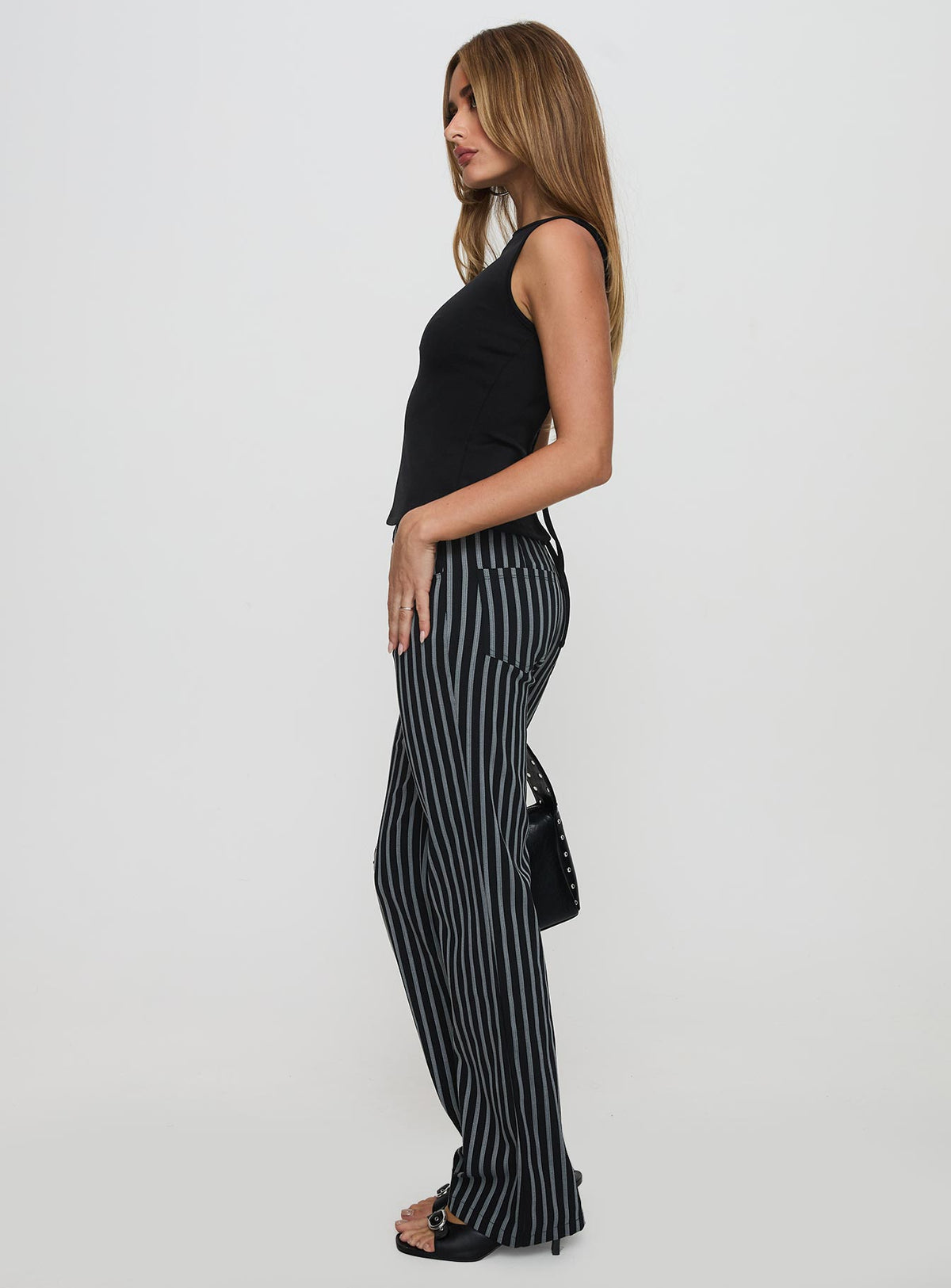 side view of model wearing Princess Polly Allude Low Waist Pinstripe Pant Black Low Rise Pants Pants 