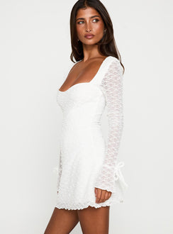 side view of model wearing Princess Polly Dalzine Long Sleeve Mini Dress White Sweetheart Neckline 