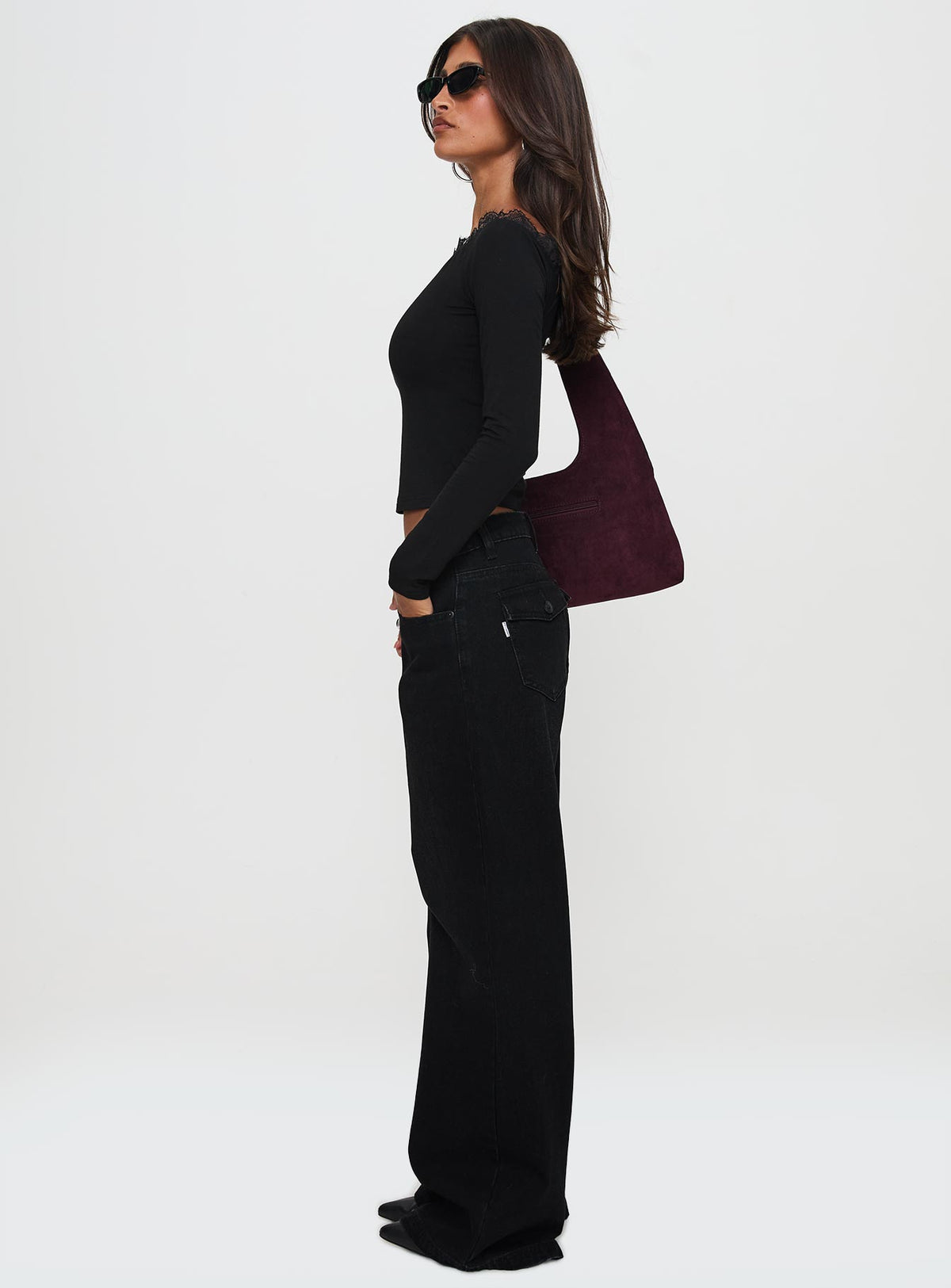 side view of model wearing Princess Polly Everlong Mid Rise Straight Leg Jeans Mid Black Wash High Rise Jeans Jeans 