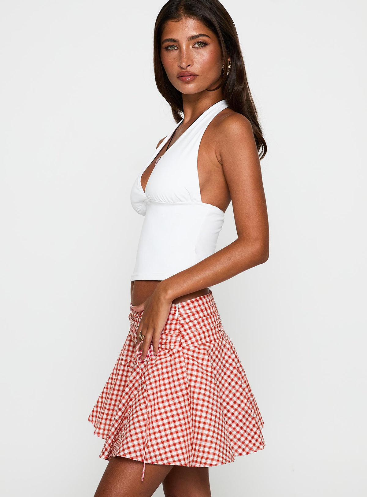   side view of model wearing Princess Polly Sweet Verona Ruched Mini Skirt Red Check Mini Skirts Skirts 
