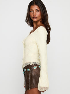 side view of model wearing Princess Polly Hyacinthe Long Sleeve Top Cream Full Sleeves Scoop Neck 