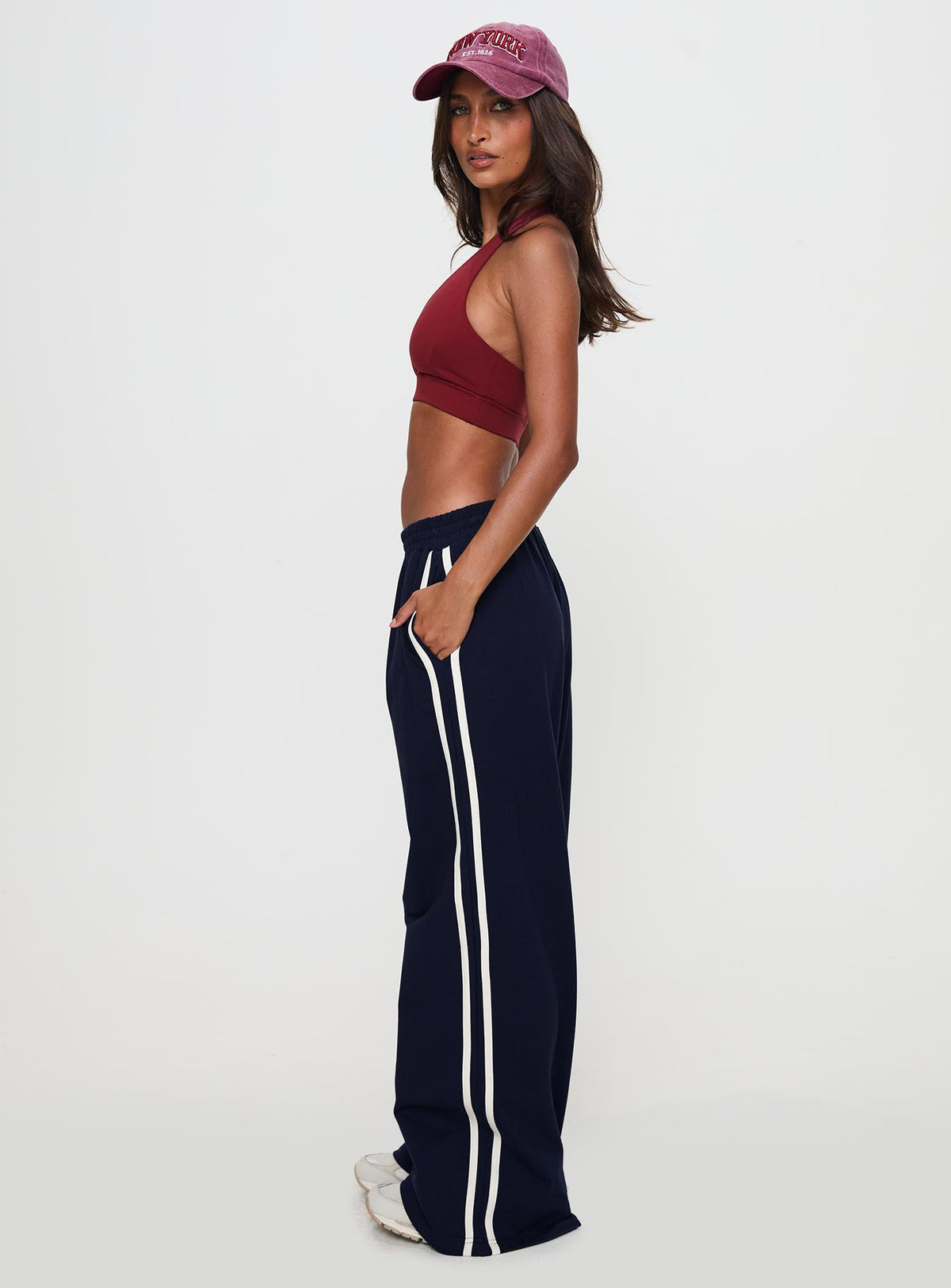 side view of model wearing Princess Polly Circuit Track Pants Navy 