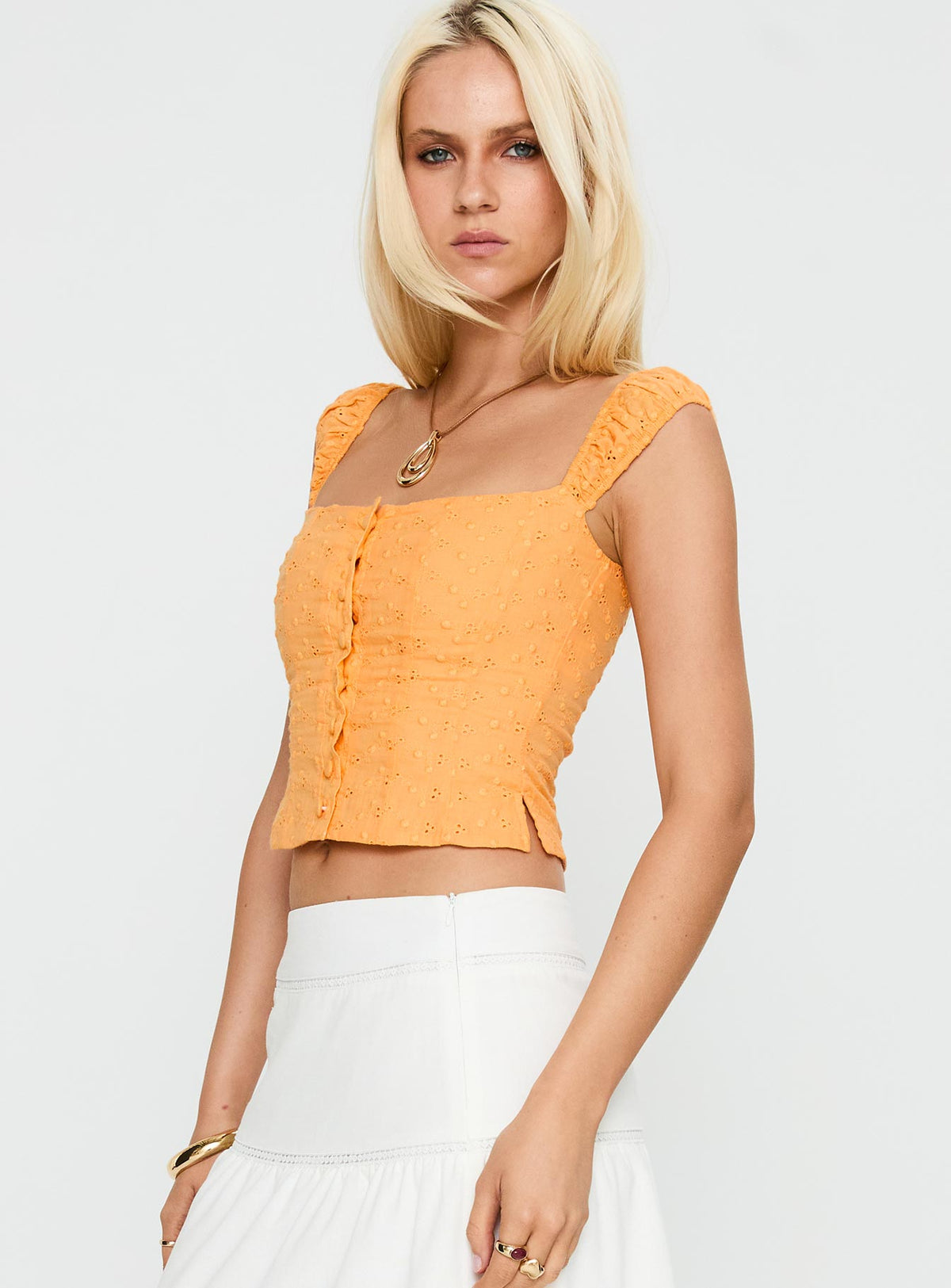 side view of model wearing Princess Polly Lyncher Top Orange Short Sleeves Square Neck 
