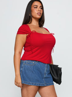   side view of model wearing Princess Polly Nicolina Low Rise Denim Mini Skirt Light Wash Curve Mini Skirts Skirts 