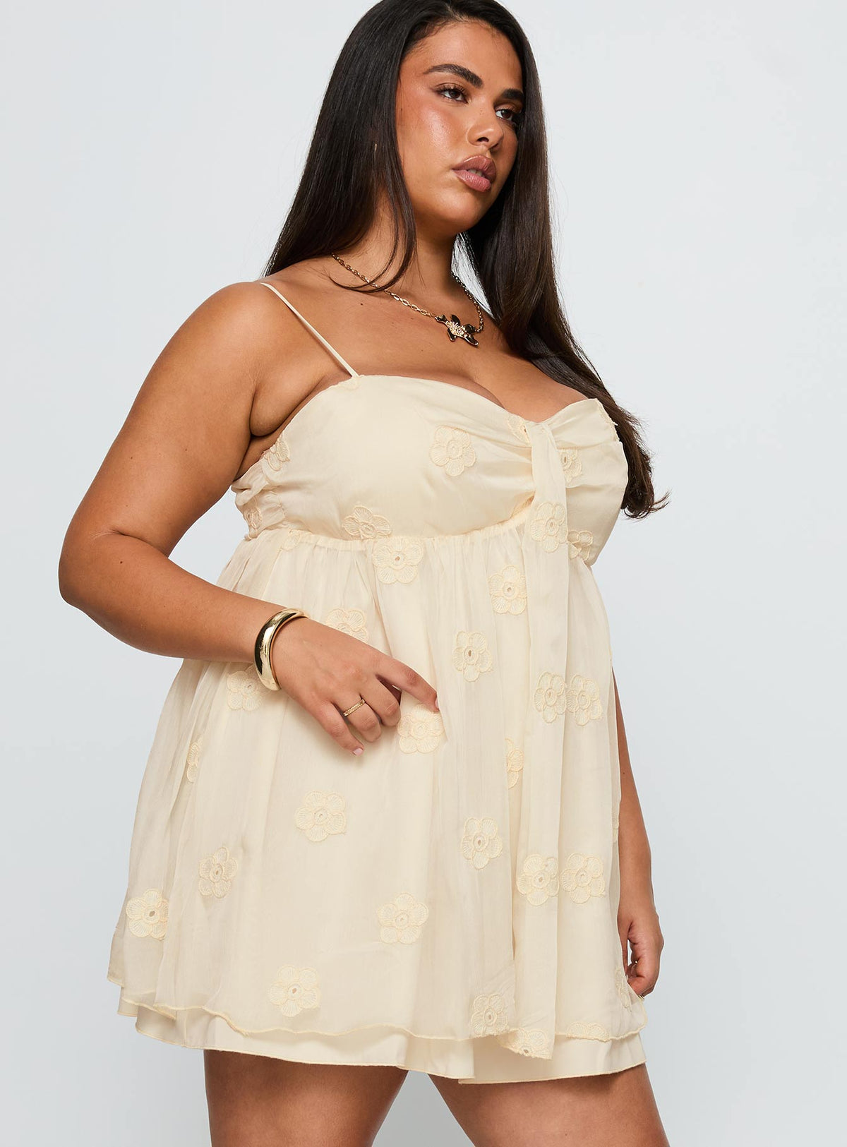 side view of model wearing Princess Polly Sparks Fly Mini Dress Cream Curve Sweetheart Neckline 