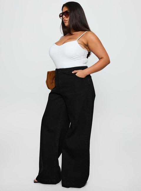 side view of model wearing Princess Polly Goldie High Rise Wide Leg Jeans True Black Curve High Rise Jeans Jeans 