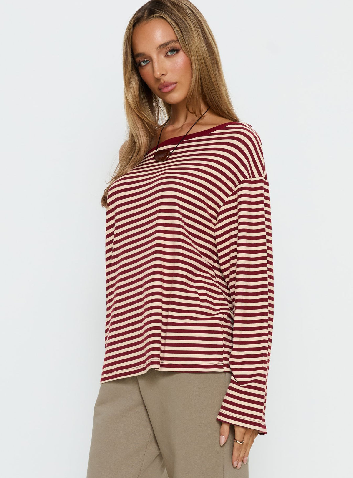 side view of model wearing Princess Polly Ralyssa Off Shoulder Long Sleeve Top Red Stripe Longline Jumpers Jumpers 