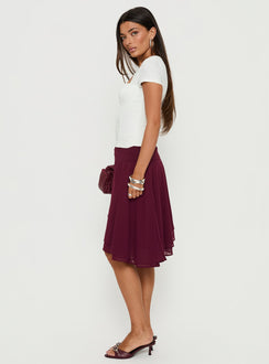   side view of model wearing Princess Polly Evanescence Asymmetrical Midi Skirt Cherry 