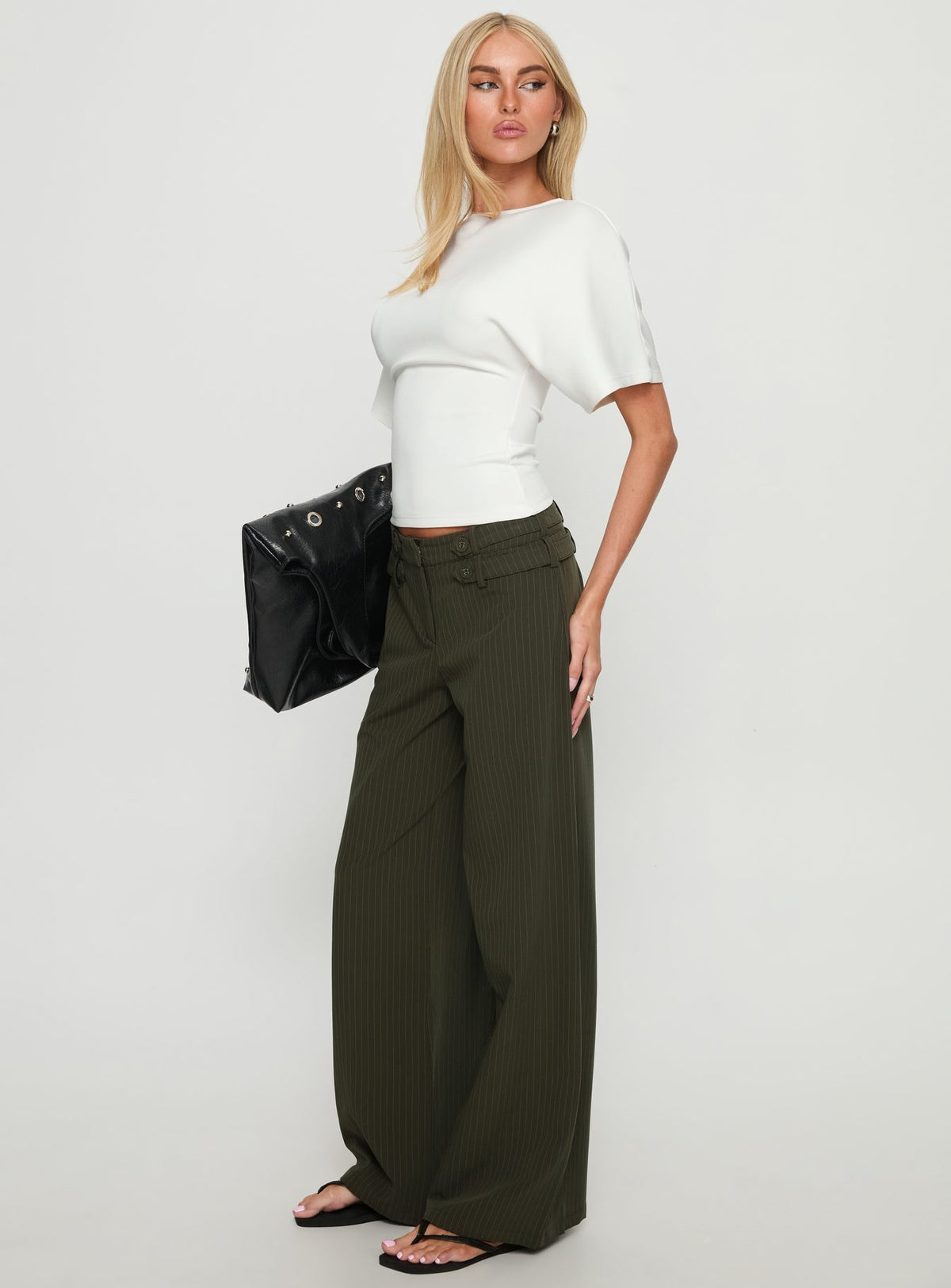 side view of model wearing Princess Polly Jette Tailored Buckle Pant Green Pinstripe High Rise Pants Pants 