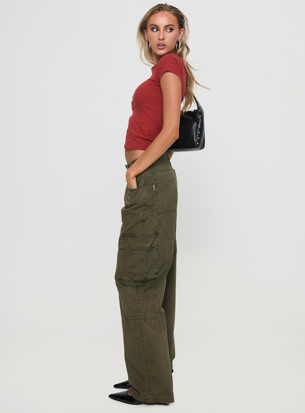 side view of model wearing Princess Polly Ahstin Cargo Jeans Green Low Rise Jeans 