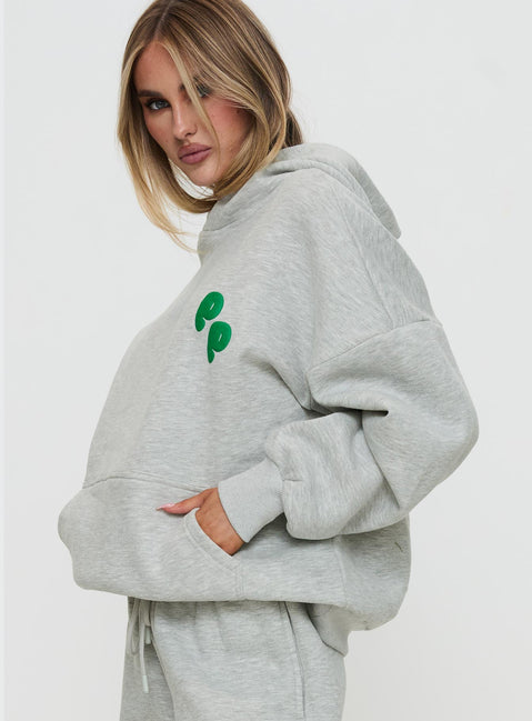 side view of model wearing Princess Polly Princess Polly Hooded Sweatshirt Bubble Text Grey Marle / Green Jumpers 