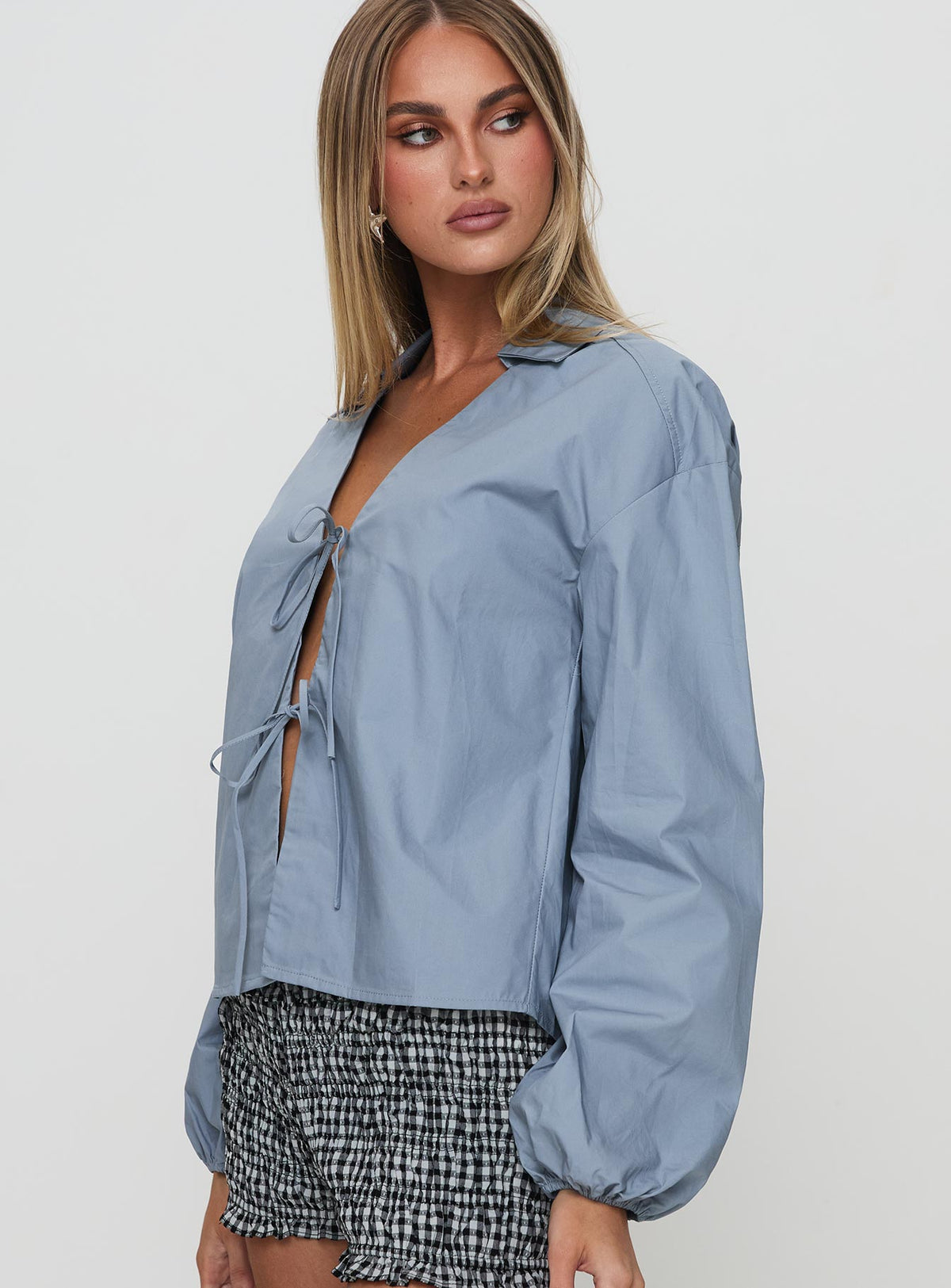 side view of model wearing Princess Polly Rinon Long Sleeve Top Steel Full Sleeves V-Neck 
