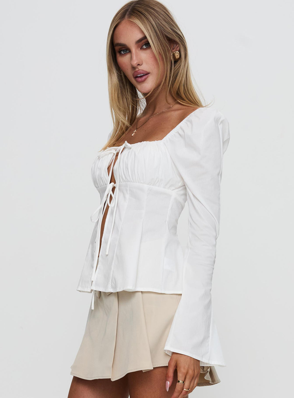 side view of model wearing Princess Polly Lilibette Tie Up Long Sleeve Top White Full Sleeves Square Neck 