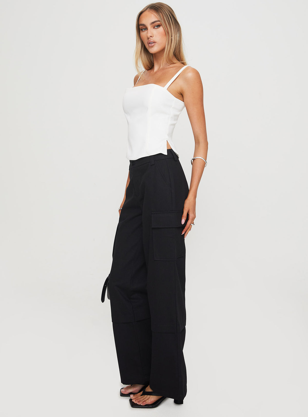 back view of model wearing Princess Polly Raider Low Waist Cargo Pant Black High Rise Pants Pants 