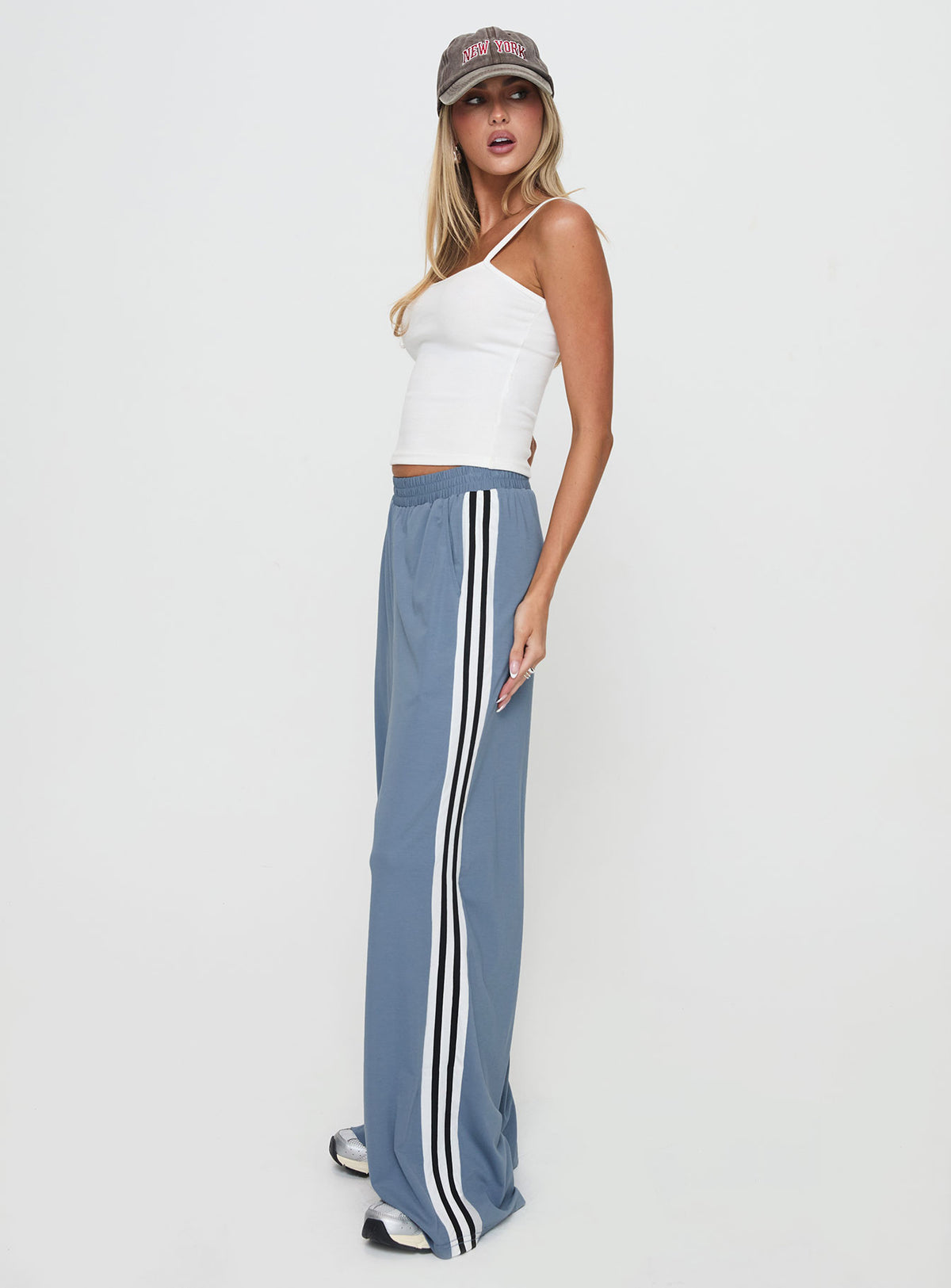 side view of model wearing Princess Polly Dime Track Pants Blue High Rise Pants Pants 