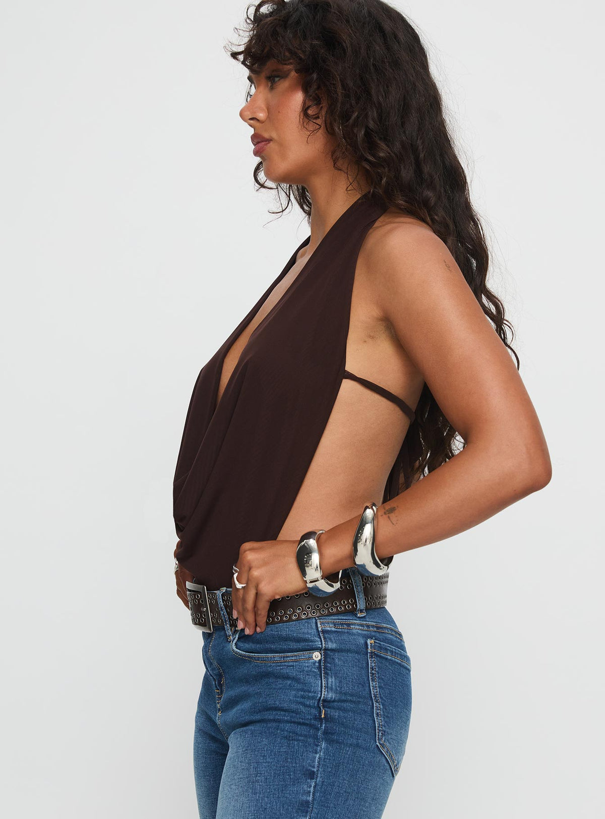 side view of model wearing Princess Polly Quinna Plunge Neck Backless Bodysuit Chocolate Sleeveless Bodysuit 