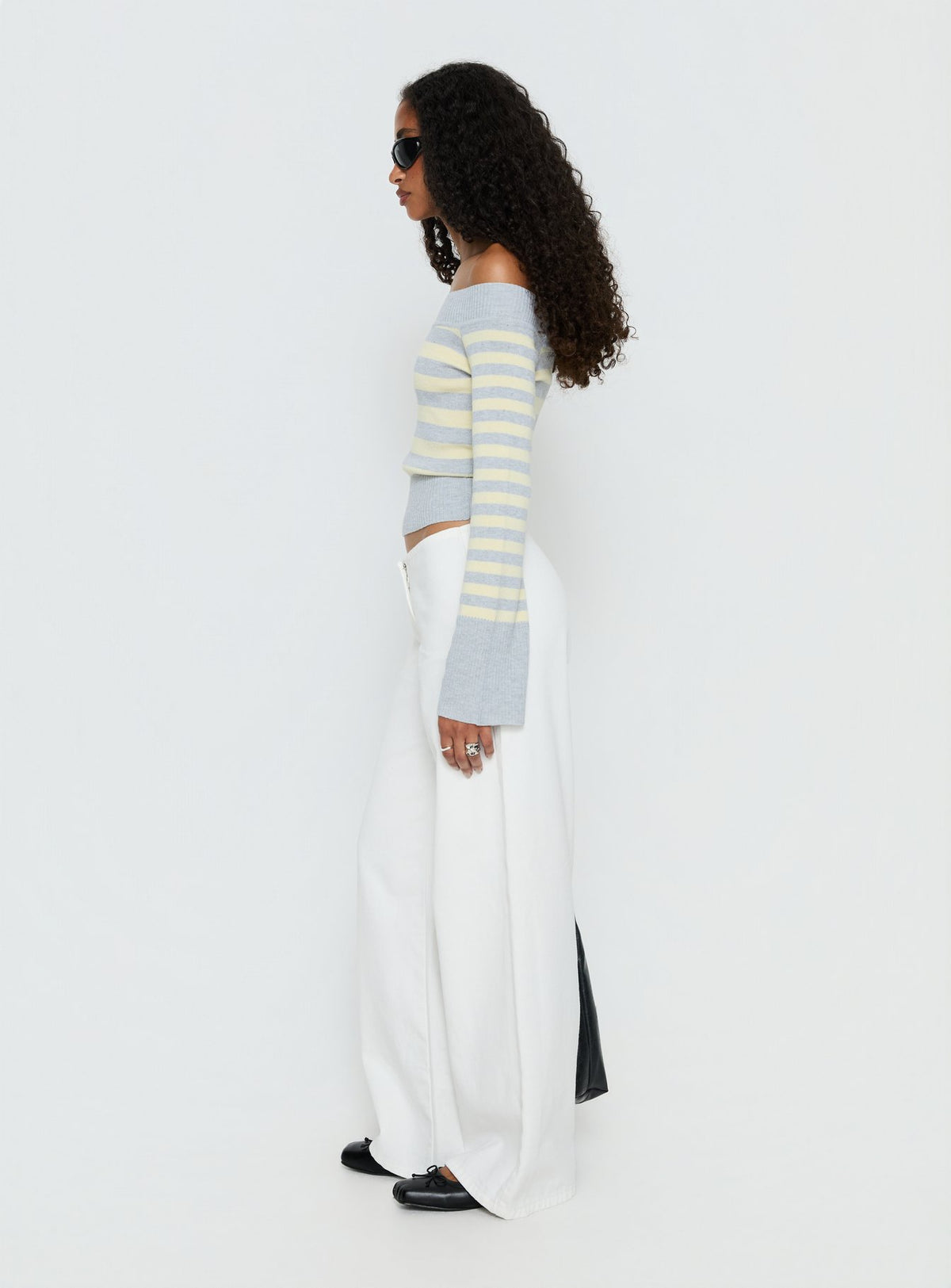side view of model wearing Princess Polly Hereos Mid Rise Baggy Leg Jeans White Mid Rise Jeans Jeans 