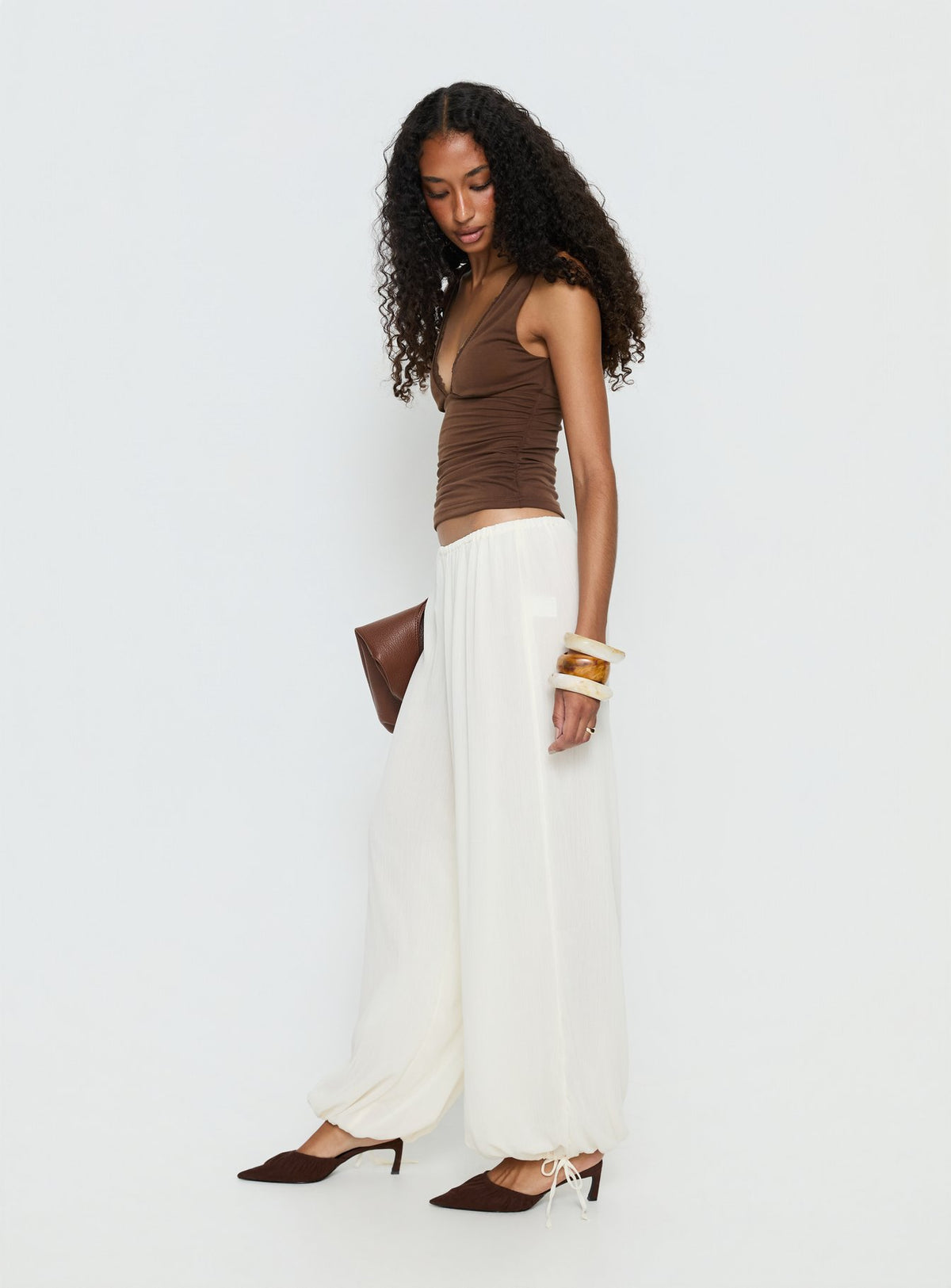 side view of model wearing Princess Polly Moondancer Balloon Pants Cream Mid Rise Pants Pants 