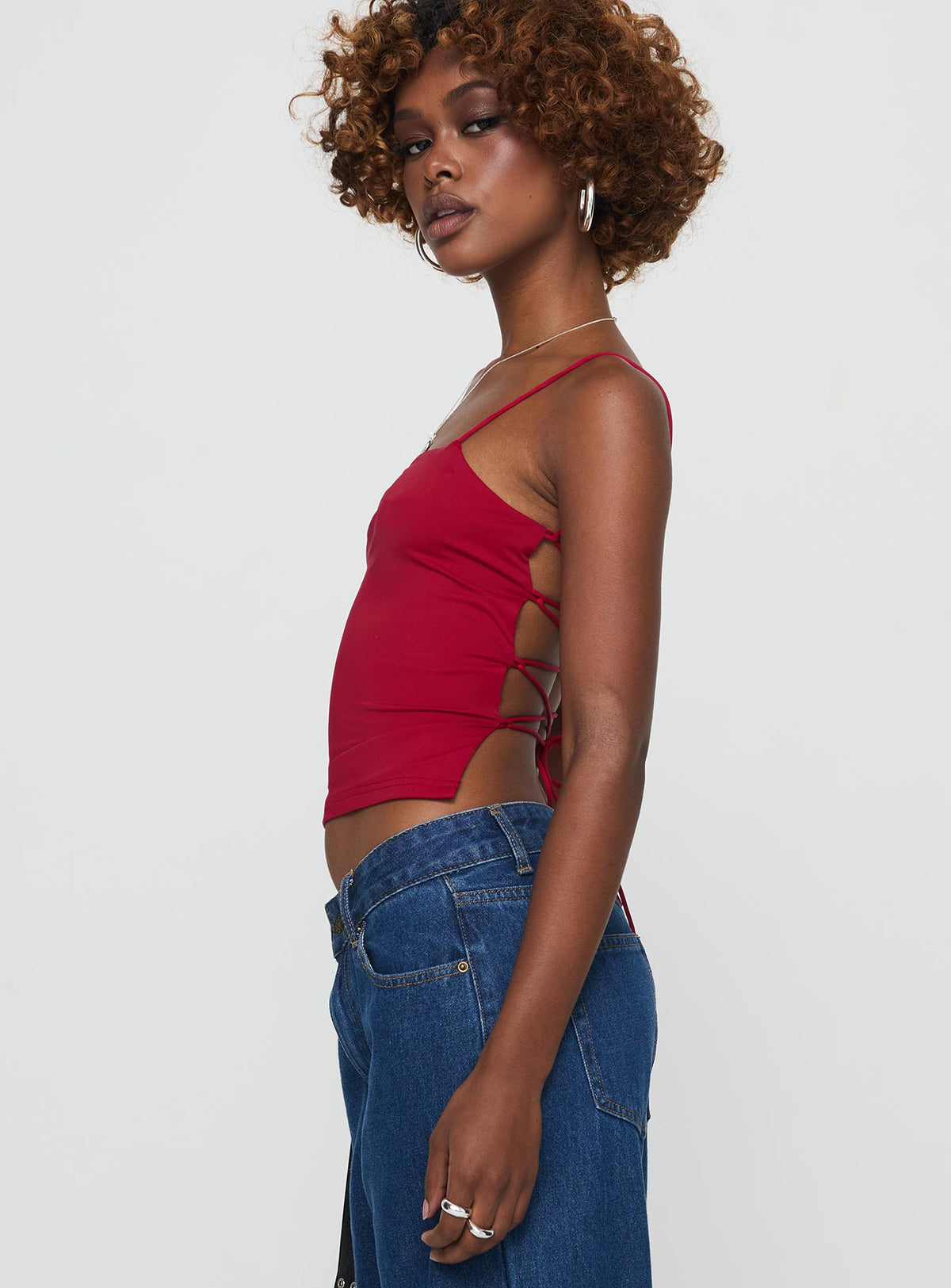 side view of model wearing Princess Polly Elissa Top Red Sleeveless Square Neck 