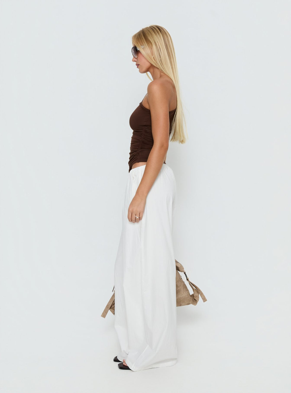 side view of model wearing Princess Polly Lunea Concealed Waistband Pants White Low Rise Pants Pants 