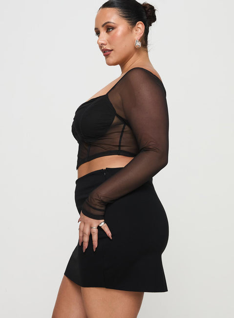   side view of model wearing Princess Polly Karley Low Waist Mini Skirt Black Curve Mini Skirts Skirts 
